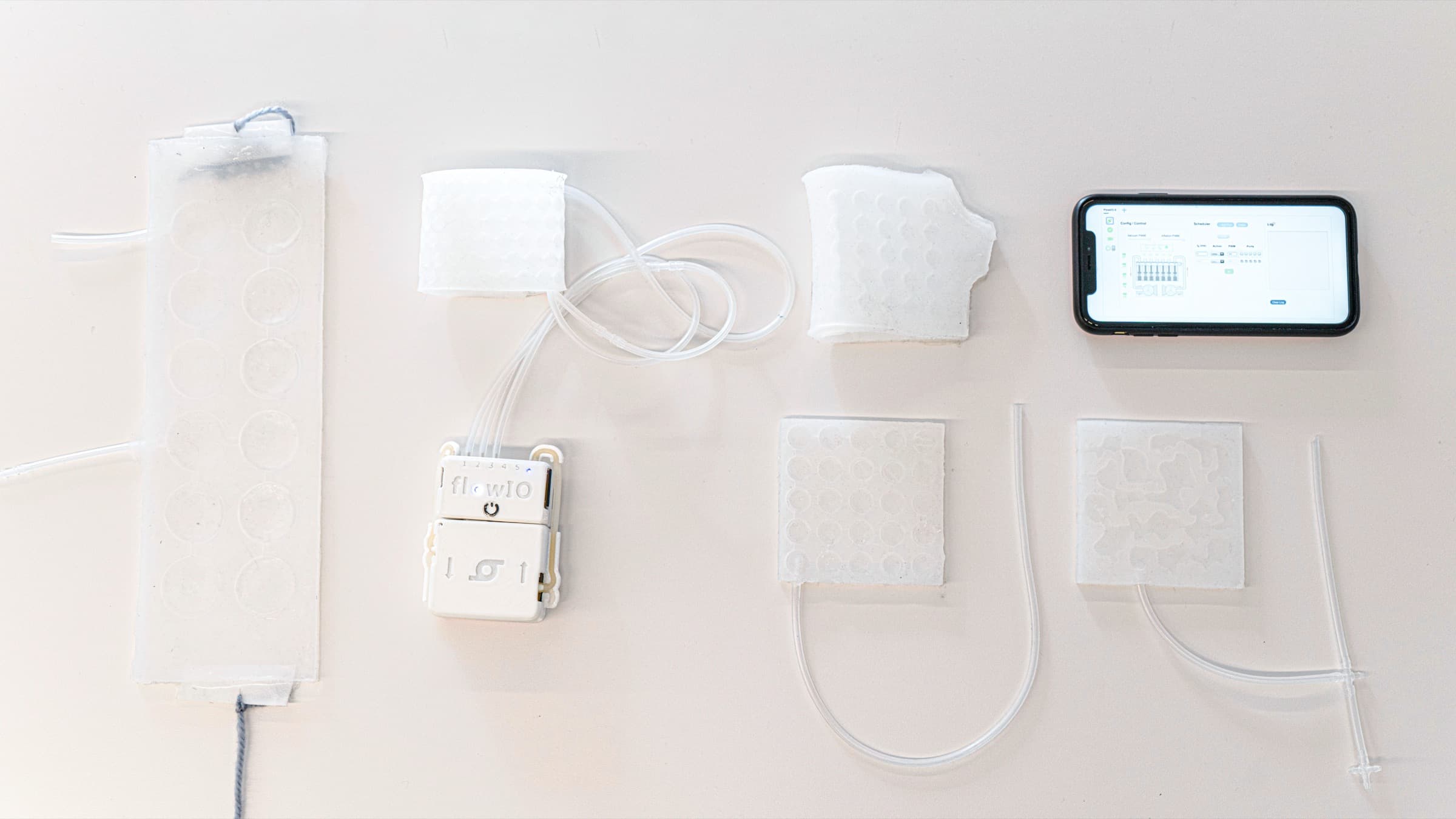 TeleCon pneumatic silicone haptic patches worn on a hand.