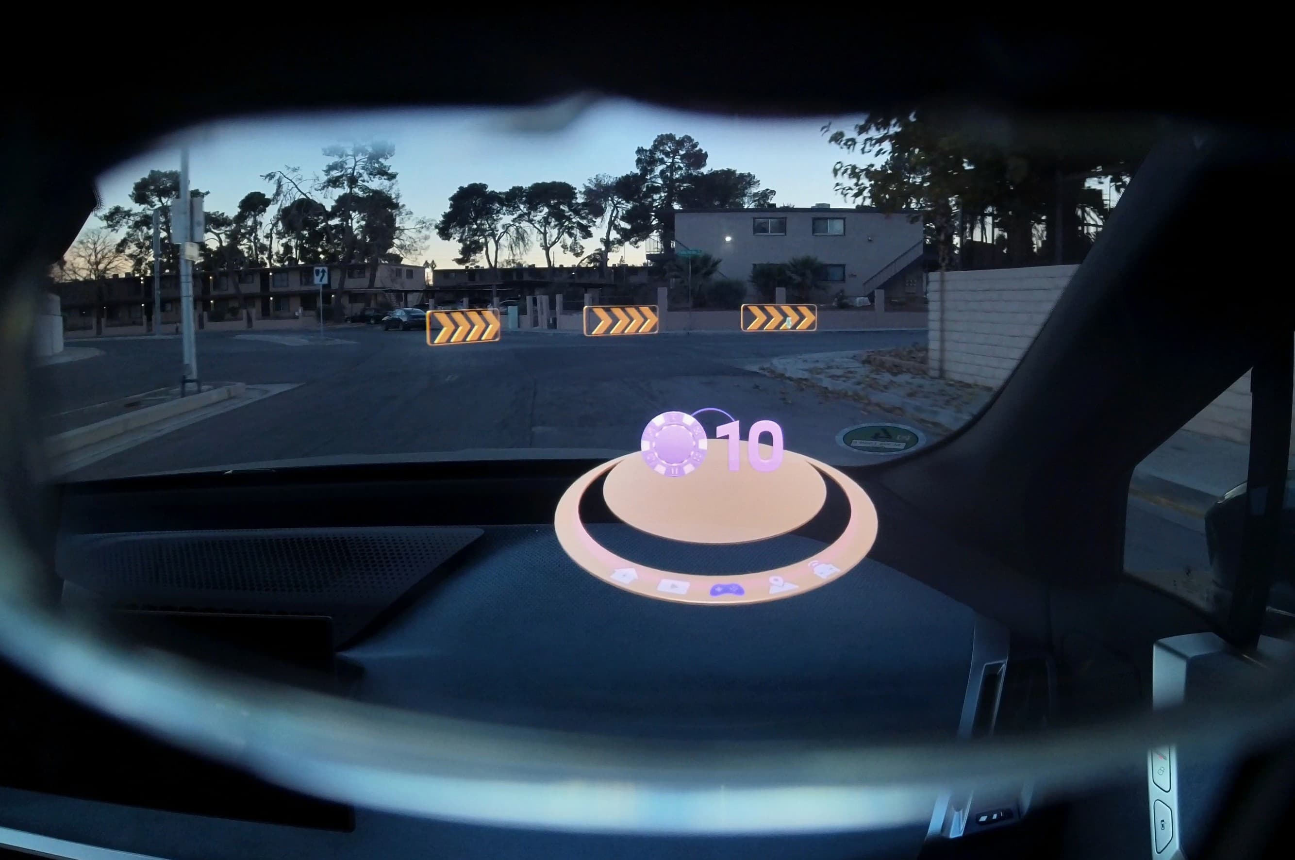 Dashboard AR game interface with road indicators ahead.