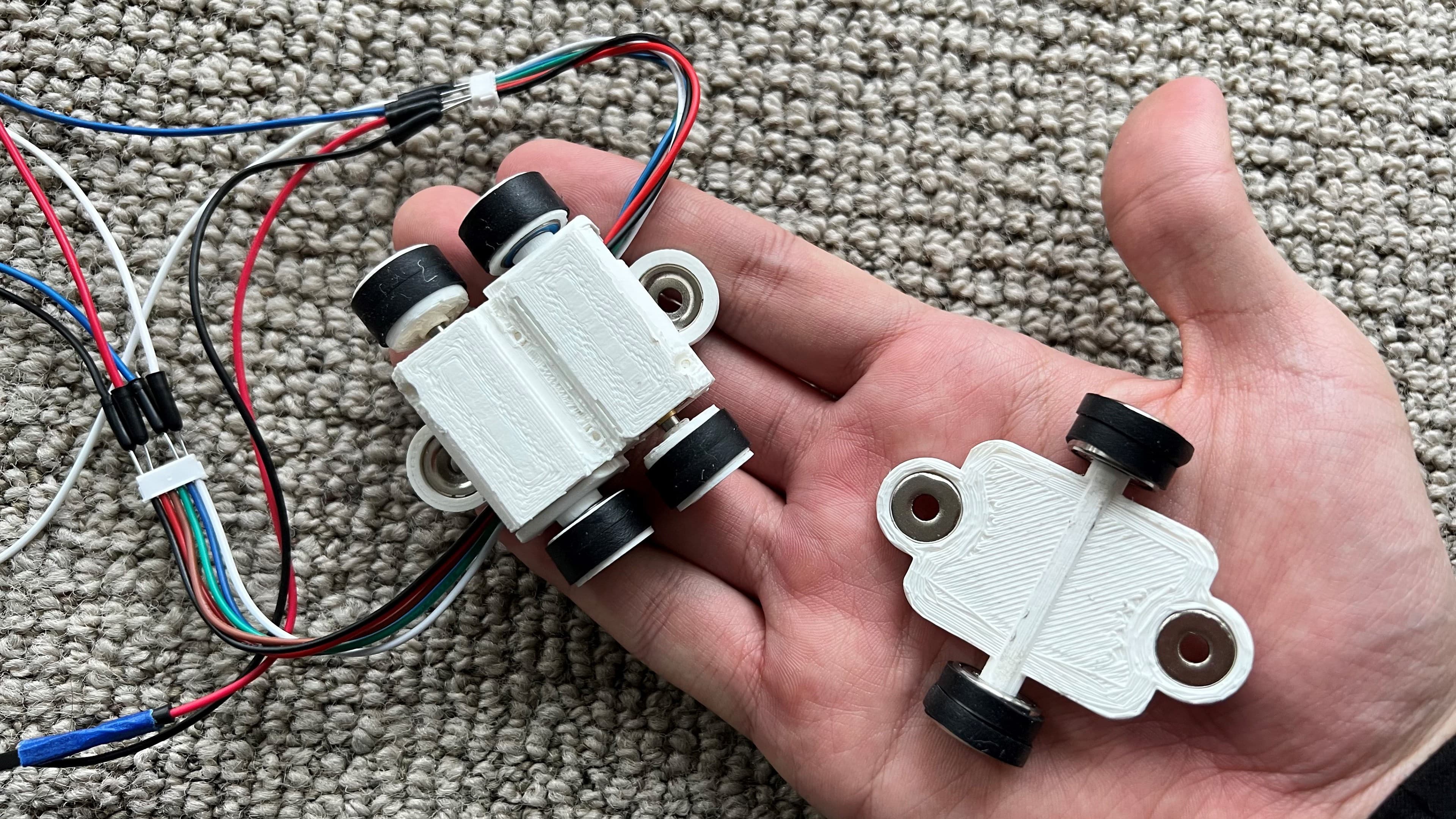 Two-part 3D-printed Climber body with embedded magnets and wheels.
